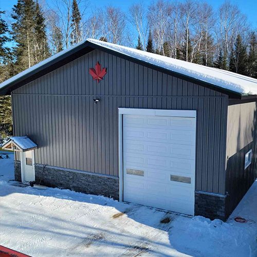 photo of large grey garage by complete carpentry