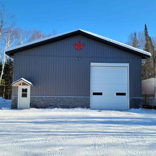 photo of large grey garage by complete carpentry